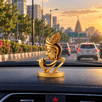 Lord Krishna idol placed on car dashboard for decoration