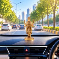 Lord Dhanvantari idol displayed on a car dashboard