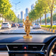 Lord Dhanvantari idol displayed on a car dashboard